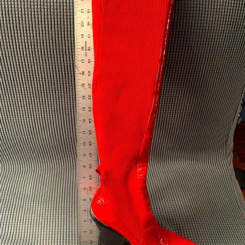 Red thigh high boots, with elastic rib backs.  Accented heels!  New like soles.